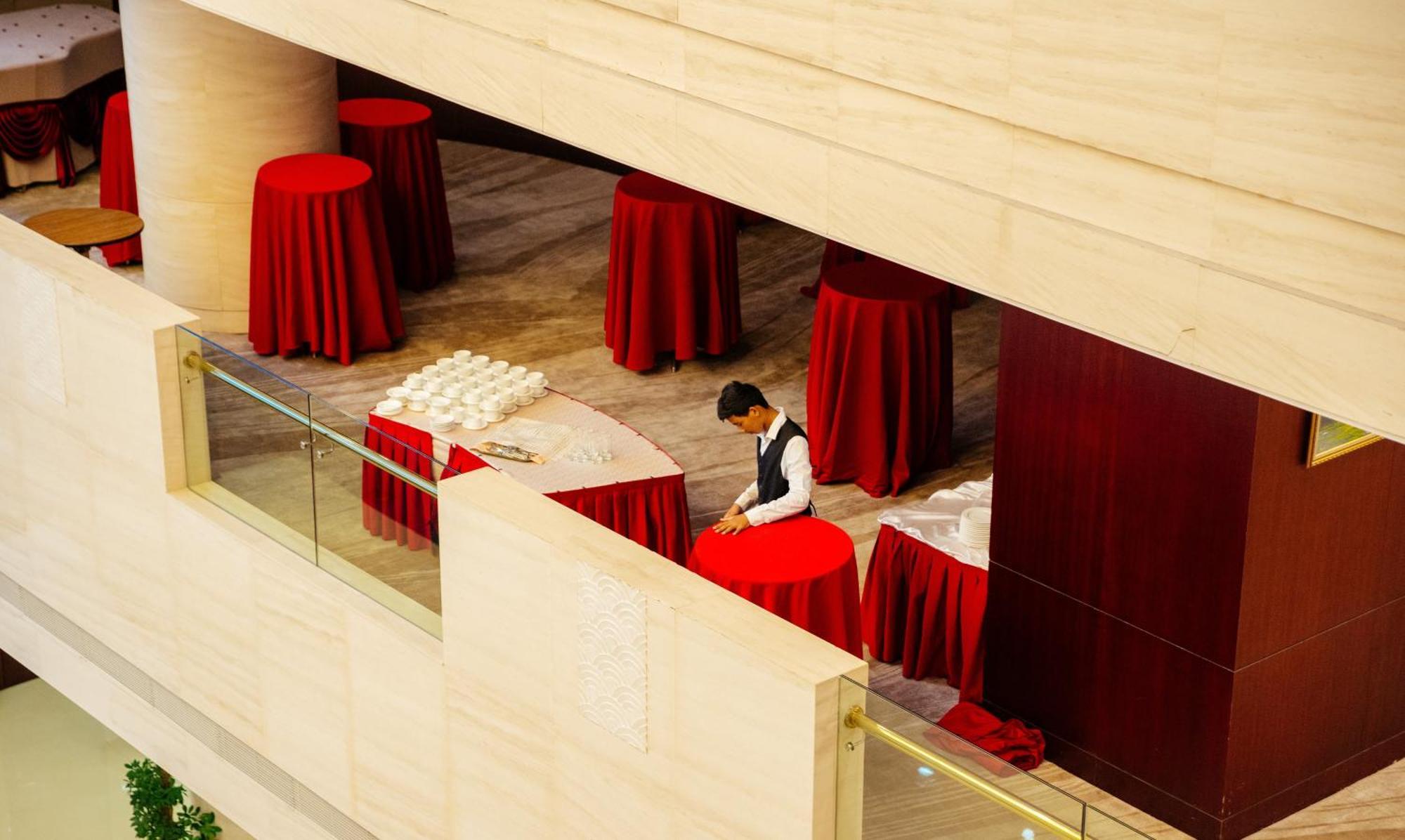 Beijing Palace Soluxe Hotel Astana Εξωτερικό φωτογραφία A hotel staff sets up a cocktail reception